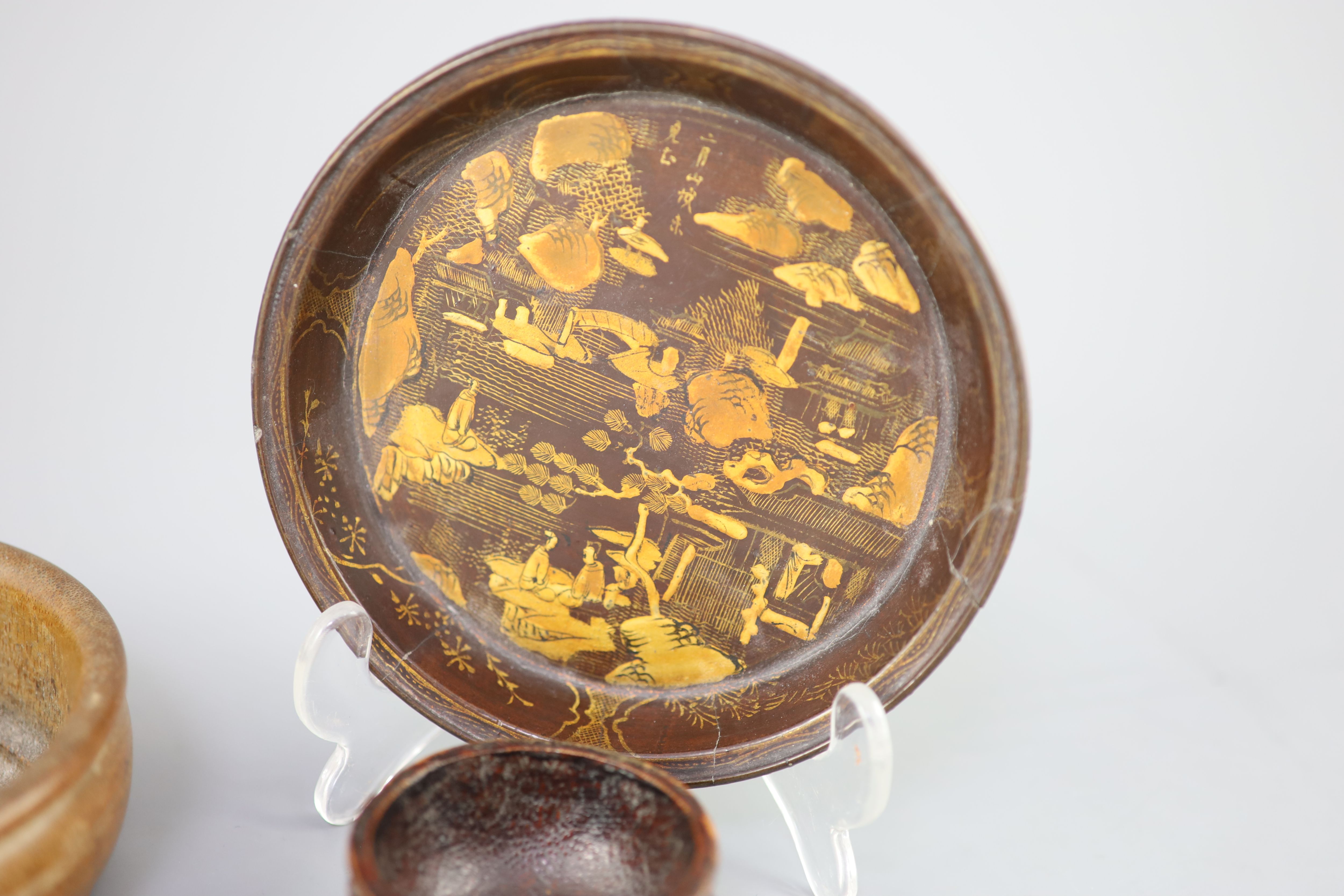 A Chinese carved bamboo cup, a plain bamboo brushwasher, 18th/19th century and a gilt decorated lacquer saucer dish, 17th century,